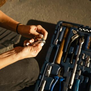 A Person Holding Steel Tool and a Bolt